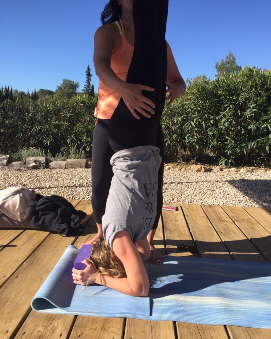 Lee-ann guiding a student into a headstand